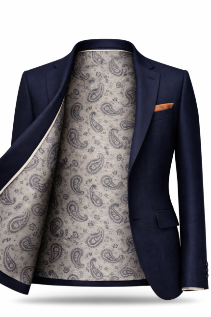 Men's navy blue suit jacket with grey paisley patterned inner lining and pocket square, premium tailored menswear.