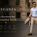 Man wearing a light blue shirt and beige tailored trousers walking confidently on a city street representing Eleganza Traders modern executive style and premium tailoring