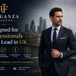 Stylish professional man in a navy tailored suit standing in London with Big Ben, representing Eleganza Traders premium business suits for UK professionals