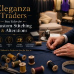 Tailor hand stitching fabric with tools and threads for custom clothing alterations at Eleganza Traders